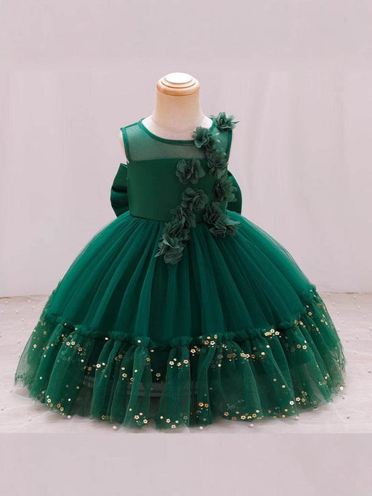 Green dress with floral details on a mannequin against a white background