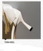 White high-heeled shoe with pearl details on a gray background
