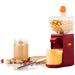 Red peanut butter maker with ingredients and a jar of peanut butter on a white background