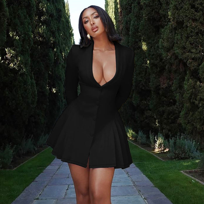 Woman in a black dress standing outdoors with greenery in the background