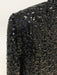 Close-up of a black sequined fabric with a white background