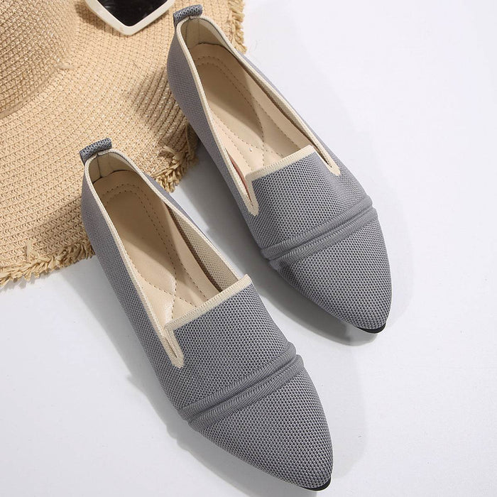 Pair of gray pointed-toe shoes on a white background