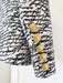 Black and white patterned coat with gold buttons on a white background