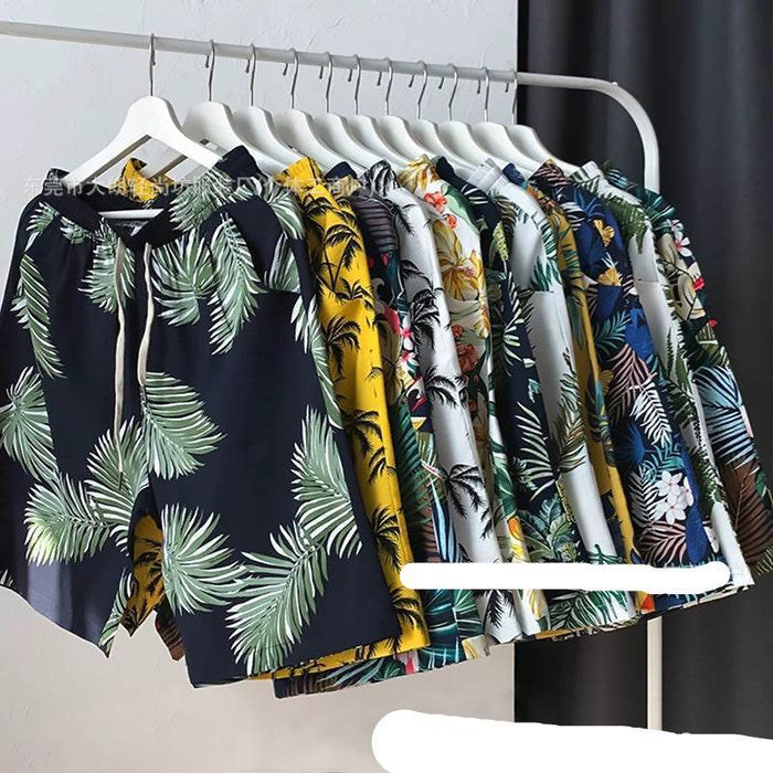 Collection of tropical patterned shirts on a rack against a dark curtain.