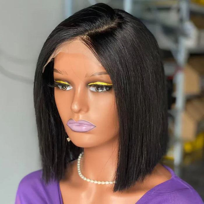 Mannequin head with a black bob wig and purple top in an indoor setting
