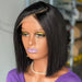 Mannequin head with a black bob wig and purple top in an indoor setting