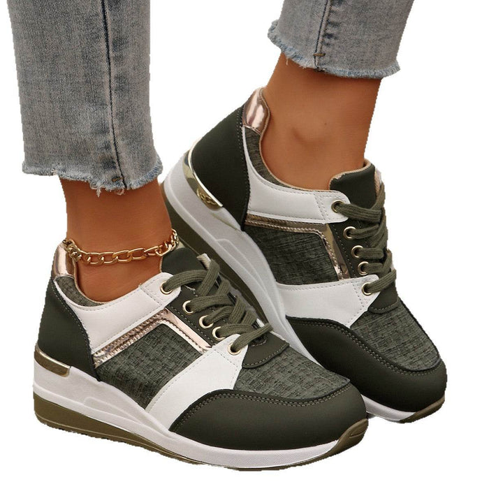 Green and white sneakers worn with gray jeans on a white background