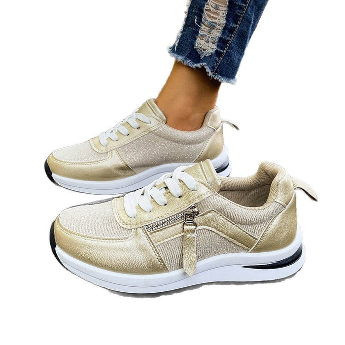 Beige sneakers with white laces on a white background