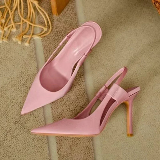 Pink high-heeled shoes on a textured surface