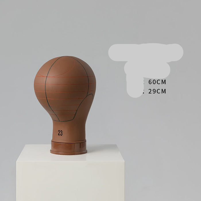 Basketball-shaped mannequin head on a white pedestal with gray background