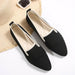 Black loafers with white soles on a light background