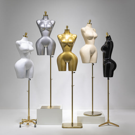 Five mannequin torsos in different colors on stands against a gray background