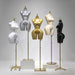 Five mannequin torsos in different colors on stands against a gray background