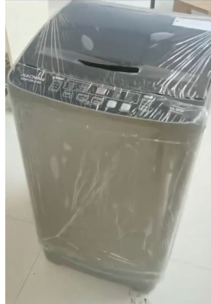 Washing machine wrapped in plastic on a tiled floor