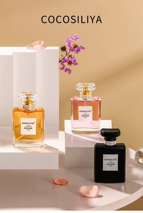 Three COCOSILIYA perfume bottles on a beige background with flowers.