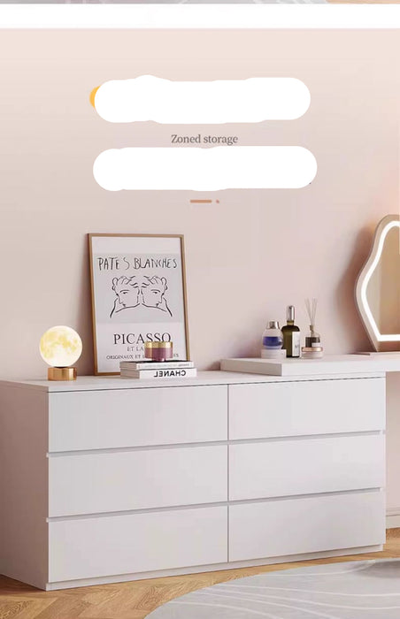 White dresser with decorative items in a room setting