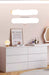 White dresser with decorative items in a room setting