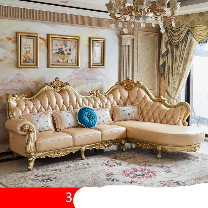 Luxurious beige sofa with gold accents in a decorated room.