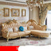 Luxurious beige sofa with gold accents in a decorated room.