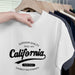 White t-shirt with 'California' text on a hanger with other shirts.
