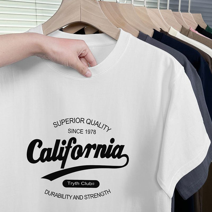 White t-shirt with 'California' text on a hanger with other shirts.