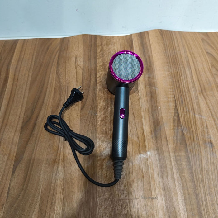 Black and purple hair dryer on a wooden surface