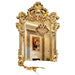 Decorative gold-framed mirror with intricate designs on a white background