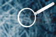 Magnifying glass over a digital representation of a CV on a blurred background